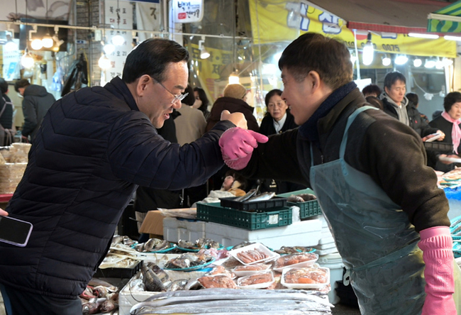주호영 국회부의장이 설 맞이 14일 장보가를 하며 상인과 팔인사를 하고 있다 .